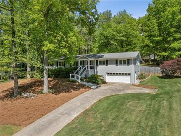 Charming home with lush landscaping, inviting curb appeal, and a well-maintained front yard at 2574 Warwick Dr, Marietta, GA 30062
