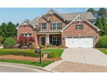 Beautiful brick home with manicured lawn, two-car garage, and inviting front porch perfect for relaxing and enjoying the neighborhood at 4650 Brighton View Trl, Cumming, GA 30040