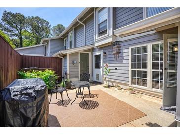 Cozy patio with a grill, seating and decor with a view of the home's exterior at 4992 Meadow Ln, Marietta, GA 30068