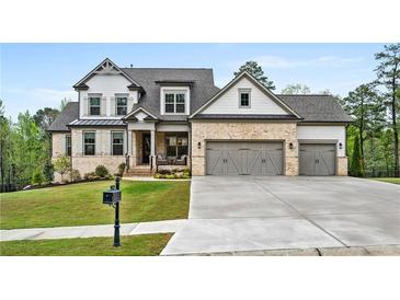 Beautiful two-story home with a brick and shingle facade, three-car garage, and well-manicured lawn at 185 Vandiver Ct, Acworth, GA 30101