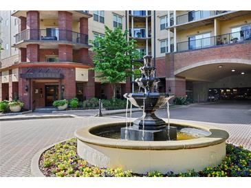 Beautiful fountain landscaping complements the brick facade of this building's exterior at 200 River Vista Dr # 423, Atlanta, GA 30339