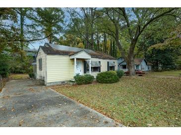 Charming one-story home with a traditional design and cozy curb appeal, surrounded by mature trees in a residential area at 3074 Delowe Dr, Atlanta, GA 30344