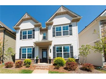 Charming two-story home with white siding, dark shutters, and a landscaped front yard at 3495 Delegate Aly, Scottdale, GA 30079
