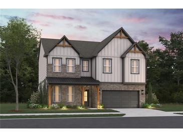 Charming two-story home featuring brick and siding, a covered porch, and an attached two-car garage at 3982 Adler Cir, Buford, GA 30519
