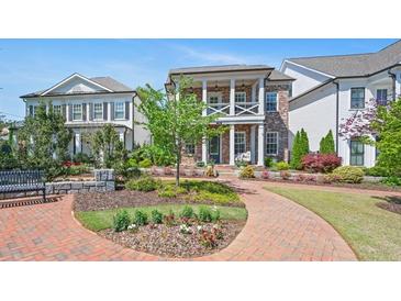 Charming two-story home boasts a landscaped front yard and inviting brick pathway at 74 Academy St, Alpharetta, GA 30009