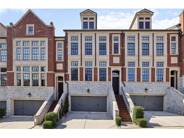 Charming brick townhomes with stone accents and individual garages at 1276 Edmund Ne Ln, Brookhaven, GA 30319