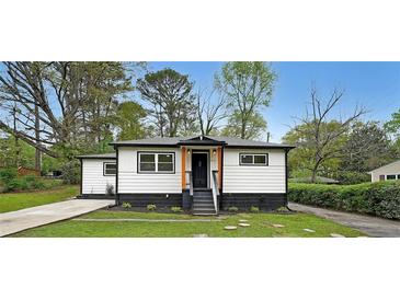 Charming renovated home with a modern black and white exterior and landscaped front yard at 2610 Knoll Se Rd, Smyrna, GA 30080