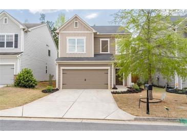 Charming two-story home featuring a two-car garage, neutral siding, and a well-manicured front yard at 275 Denver Ave, Hiram, GA 30141