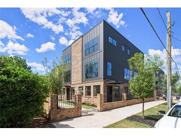 Modern home featuring a mix of brick and metal, plus ample windows for natural light at 1123 W Marietta St, Atlanta, GA 30318