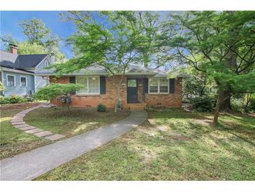 Charming brick home with mature trees, walkway, and inviting curb appeal at 108 Glenn St, Decatur, GA 30030