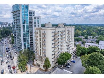 View of the high-rise condo building with balconies and city skyline in the background at 2161 Peachtree Ne Rd # 605, Atlanta, GA 30309