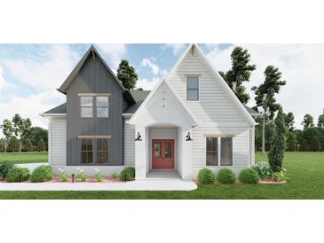Beautiful two-story home featuring a landscaped front yard and a charming red front door at 6565 Rhett Run, Cumming, GA 30028