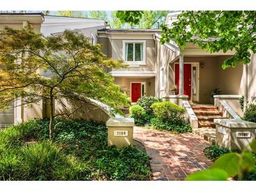Inviting townhome with a brick path leading to a bright red door and lush landscaping at 3188 Paces Mill Se Rd, Atlanta, GA 30339