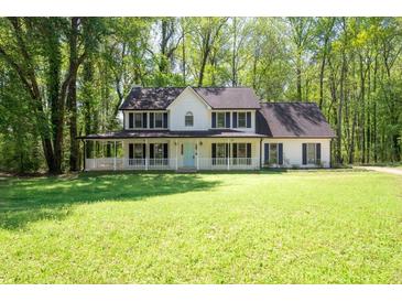 Charming two-story home with a full front porch and a well-manicured lawn at 1061 Retner Dr, Mableton, GA 30126