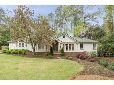 Charming home exterior with manicured lawn and blooming tree providing curb appeal at 3038 Nancy Creek Nw Rd, Atlanta, GA 30327