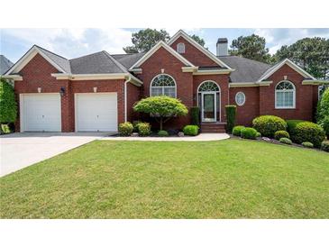 Charming brick home with a well-maintained lawn and a two-car garage at 4955 Kingsbridge Ct, Powder Springs, GA 30127