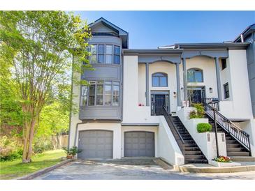 Elegant townhome featuring a two-car garage and grand entrance staircase at 1015 Heatherbrooke Ln, Atlanta, GA 30324
