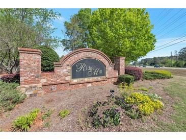 Welcoming entrance sign for Ridge Mill featuring brick pillars and colorful landscaping at 310 Oak Leaf Pl, Acworth, GA 30102