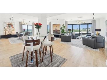 Bright open-plan living area featuring floor-to-ceiling windows, light wood floors, and elegant contemporary furnishings at 3475 Oak Valley Ne Rd # 1720, Atlanta, GA 30326