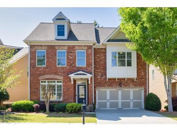 Charming brick two-story home with well-maintained landscaping and attached two-car garage at 3810 Baverton Dr, Suwanee, GA 30024