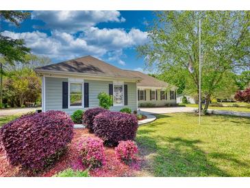 Charming single-story home with manicured lawn, lovely landscaping, and welcoming curb appeal at 72 Grayson New Hope Rd, Grayson, GA 30017