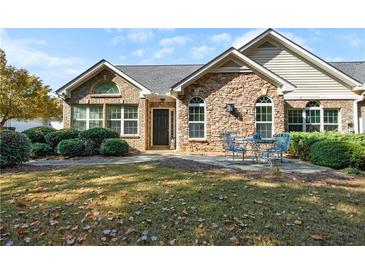 Charming home with stone accents, arched windows, and a cozy front patio at 4573 Caleb Xing # 20, Powder Springs, GA 30127