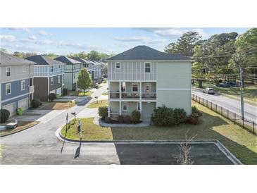 Charming two-story home with double balconies and a well-manicured front lawn at 725 Mcwilliams Se Rd, Atlanta, GA 30315