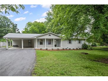 Charming single-story home with covered porch, carport and landscaped front yard at 1830 Mayfield Rd, Alpharetta, GA 30009
