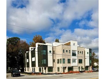 Modern townhome featuring gray and white brick, contemporary architectural details, and plenty of natural light at 1968 8Th St, Chamblee, GA 30341