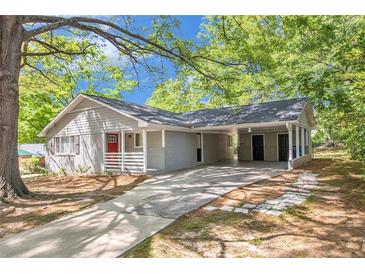 Charming single-story home with grey siding, carport, well-maintained lawn, and mature shade trees at 2925 Heather Dr, Atlanta, GA 30344