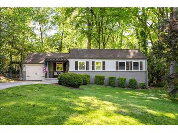 Charming single-story home features lush landscaping and an inviting exterior at 1002 Forrest Blvd, Decatur, GA 30030