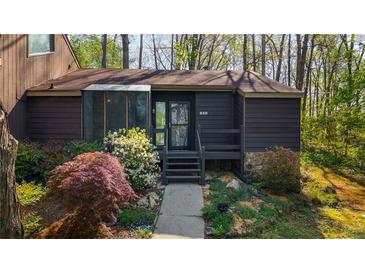Charming single story home featuring a beautifully landscaped yard and stone accents on the facade at 859 Bridgewater Ct, Stone Mountain, GA 30088