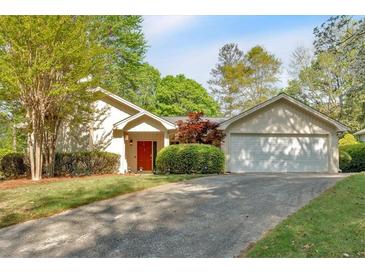 Charming single-story home with a well-manicured lawn, driveway, and attached garage at 30 Sweetwood Ct, Roswell, GA 30076