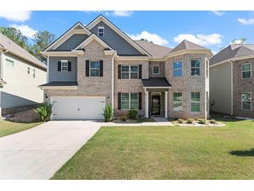 Charming two-story home with manicured lawn, brick facade, and a two-car garage at 550 Breton Highlands, Fairburn, GA 30213