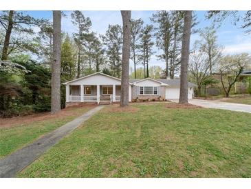 Charming ranch-style home with a welcoming front porch and well-maintained lawn, creating inviting curb appeal at 2000 Hill Rd, Marietta, GA 30062