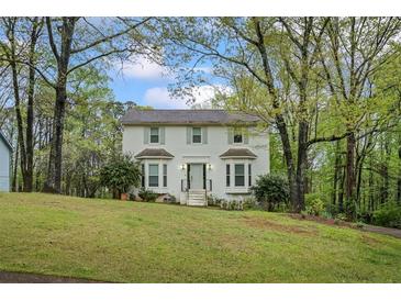 Charming two-story home with landscaped yard and lush trees in a desirable neighborhood at 2645 Sandstone Dr, Lawrenceville, GA 30043
