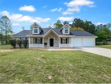 Charming one-story home with dormer windows, a two-car garage, a covered porch, and a spacious front yard at 41 Olde Town Way, Rockmart, GA 30153