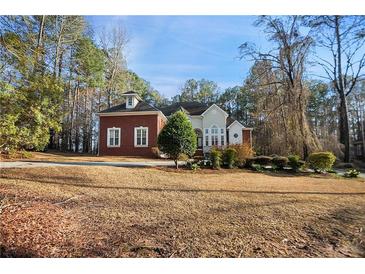 Well-manicured front yard of a charming home with a combination of brick and stucco exterior at 175 Oak Manor, Fayetteville, GA 30214