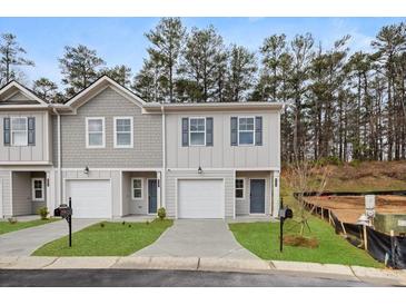 Charming two-story townhome with attached garage, fresh landscaping, and neutral color palette at 4258 Sw Notting Hill Dr # 32, Atlanta, GA 30331