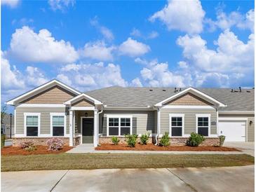 Charming single-story home with well-manicured landscaping, beautiful lawn and inviting curb appeal at 2959 Rambler Dr, Loganville, GA 30052