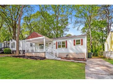 Charming bungalow with a covered front porch, green lawn, and inviting curb appeal at 269 Moreland Way, Atlanta, GA 30354