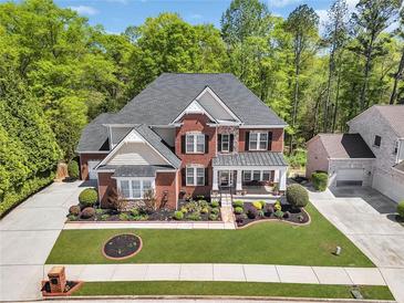 Beautiful two-story brick home featuring a landscaped front yard, charming porch, and attached garage at 3120 Abbey Sw Dr, Atlanta, GA 30331