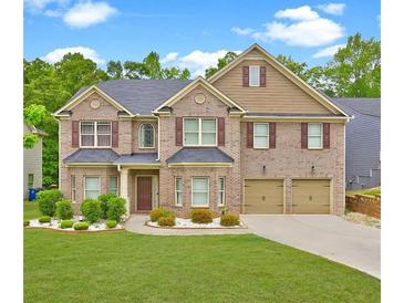 Charming brick home with a well-manicured lawn and a two-car garage at 5280 Clingman Ct, Douglasville, GA 30135