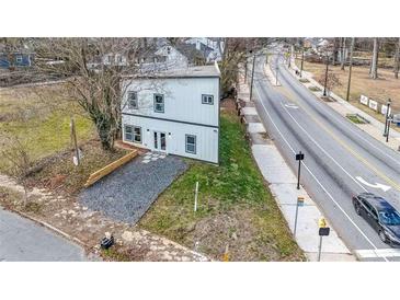 Modern two-story home with a sleek white exterior, gravel driveway, and minimal landscaping at 125 Laurel Sw Ave, Atlanta, GA 30314