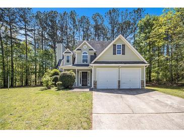 Charming two-story home with a two car garage and manicured lawn surrounded by mature trees at 432 Tanner Farm Dr, Rockmart, GA 30153