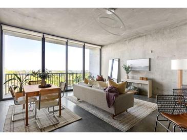 Bright living room with large windows, city views, modern furnishings, and stylish decor at 480 John Wesley Dobbs Ne Ave # 716, Atlanta, GA 30312