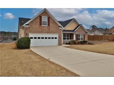 Charming brick home with a two-car garage, well-maintained lawn, and a welcoming entrance at 1104 Aqua Shore Dr, Mcdonough, GA 30252