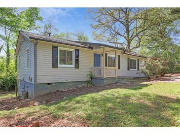 Charming single-story home with siding, a front porch, and lush landscaping at 5942 Morgan Rd, Atlanta, GA 30340