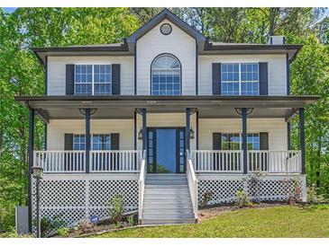 Charming two-story home featuring a welcoming front porch and manicured lawn at 1331 Windage Sw Ct, Marietta, GA 30008