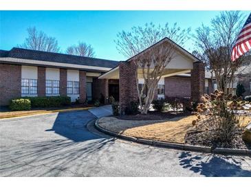 Inviting brick building featuring well-maintained landscaping, offering a welcoming facade at 475 Mount Vernon Ne Hwy # C-220, Sandy Springs, GA 30328